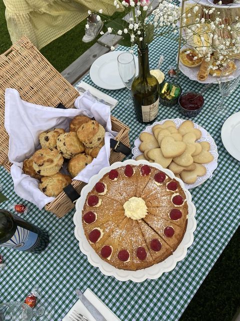 Victoria sponge, scones and biscuits on a gingham table