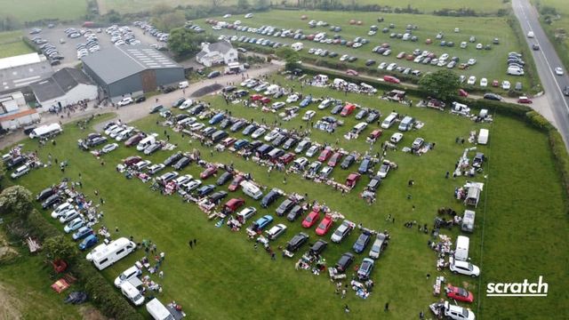 Aerial view of cars and stalls in the field
