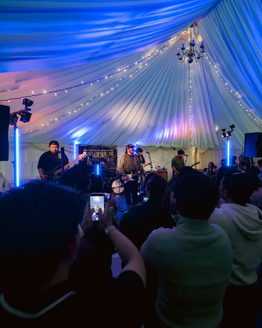 Band playing under blue stage lights