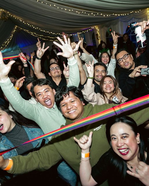 A cheering crowd at a concert in the marquee