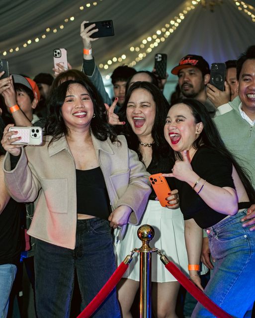 Friends taking selfies at the barrier