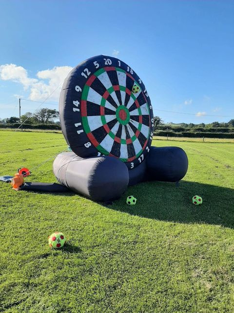 Giant inflatable football dartboard on the grass