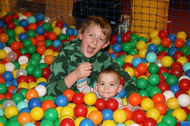 Two smiling boys in the Fun Barn ball pit