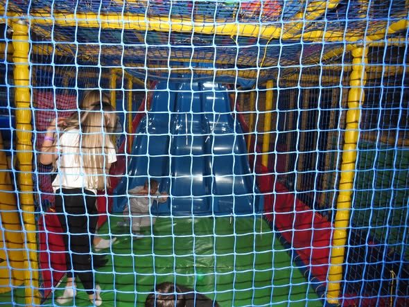 Inside the netted climbing frame with the slide ahead
