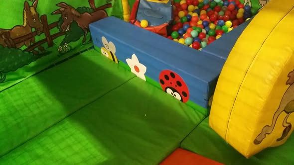 Soft play toddler area with a small ball pit and soft shapes