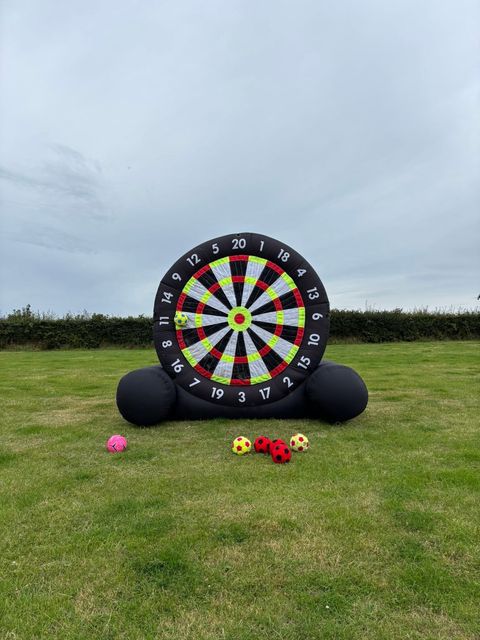 Giant inflatable dartboard with footballs
