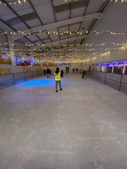 The indoor rink with fairy lights strung across the ceiling