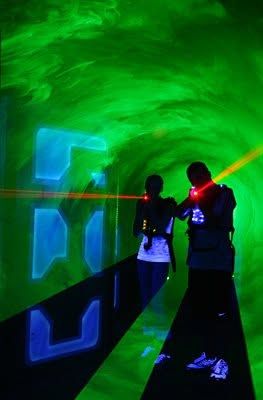 Two players in the green-lit laser tunnel