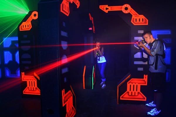 Red laser beams in the blacklit arena