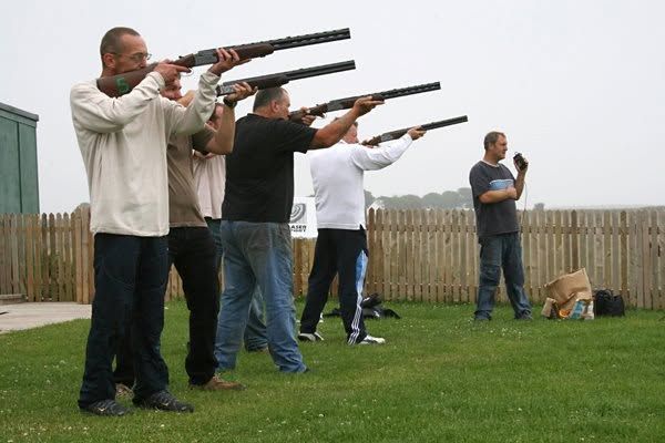 A group trying laser clay shooting