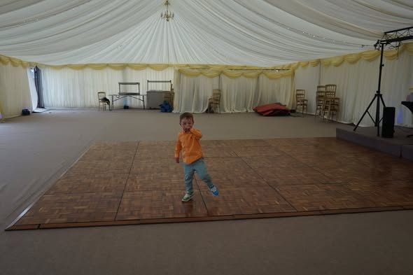 The empty marquee with a wooden dance floor laid in the middle