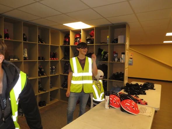 Shelves of hire skates and helmets at the skate hire desk