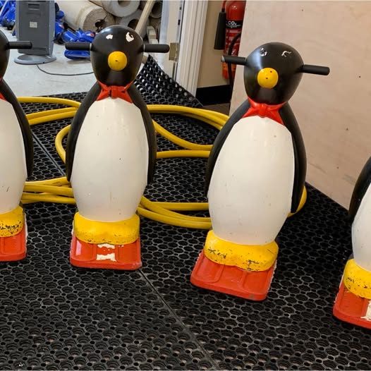 Penguin skating aids lined up by the rink
