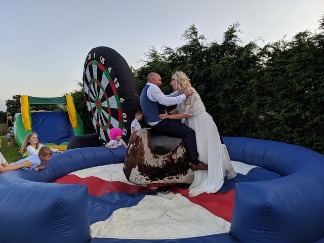 Bride and groom sitting on the rodeo bull