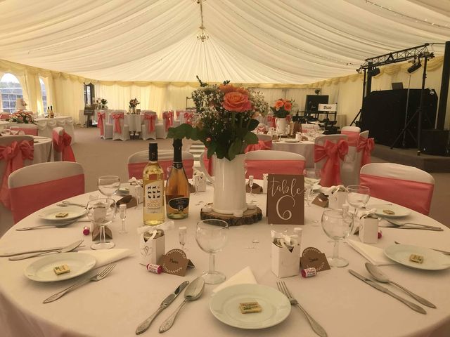A wedding table laid with flowers, glasses and a table number