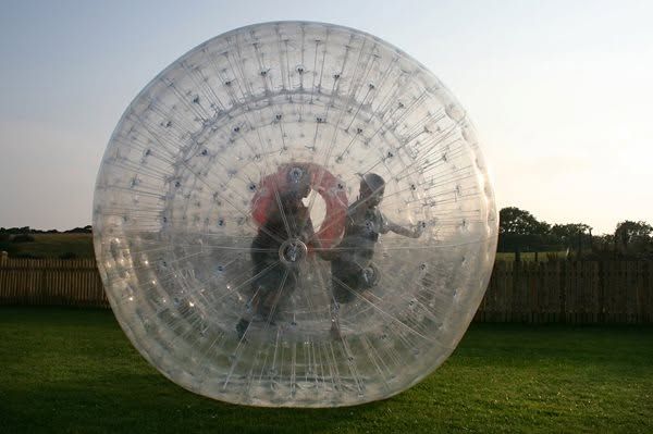 Two people inside a giant zorb ball